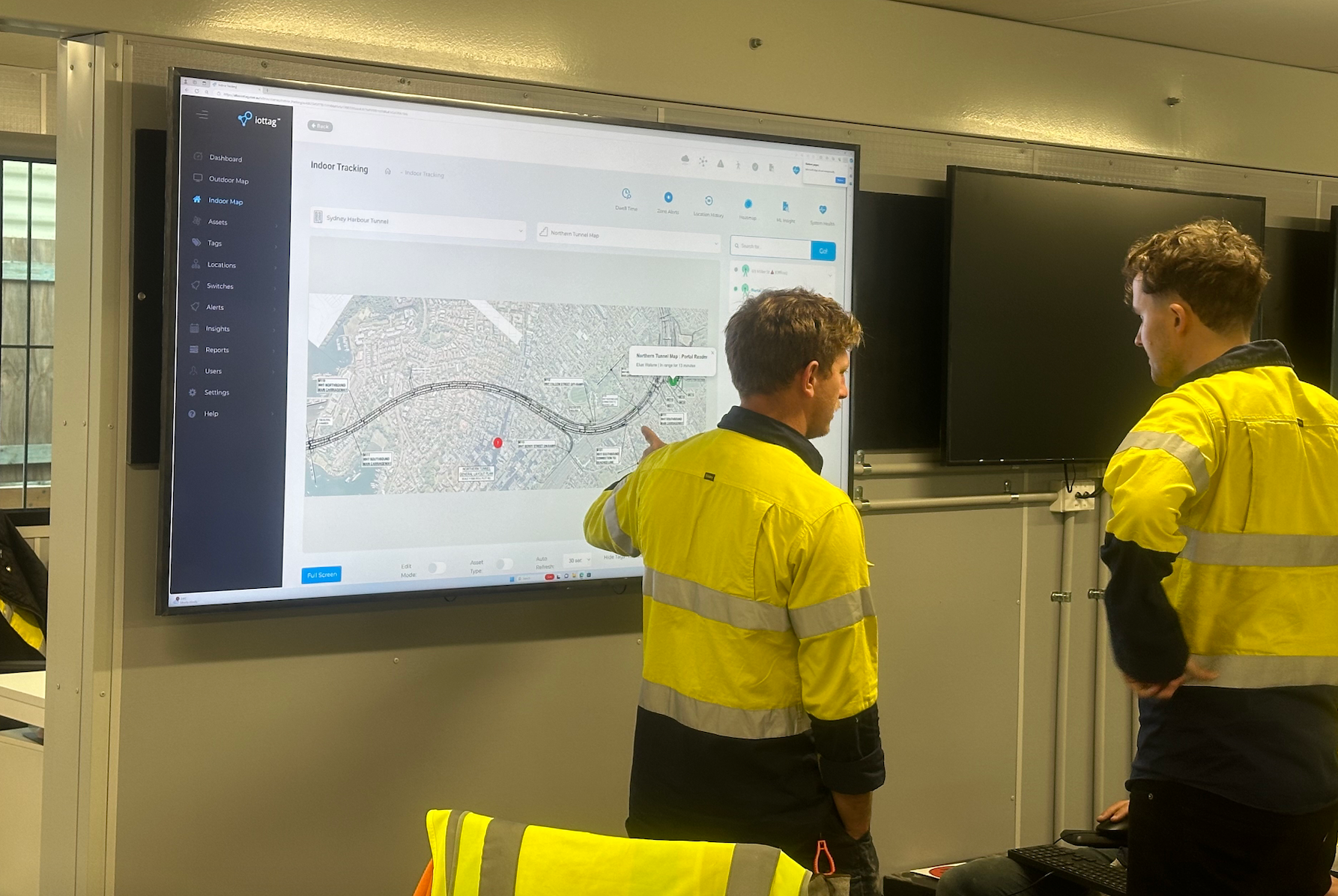Project team reviewing the iottag site map in a site office